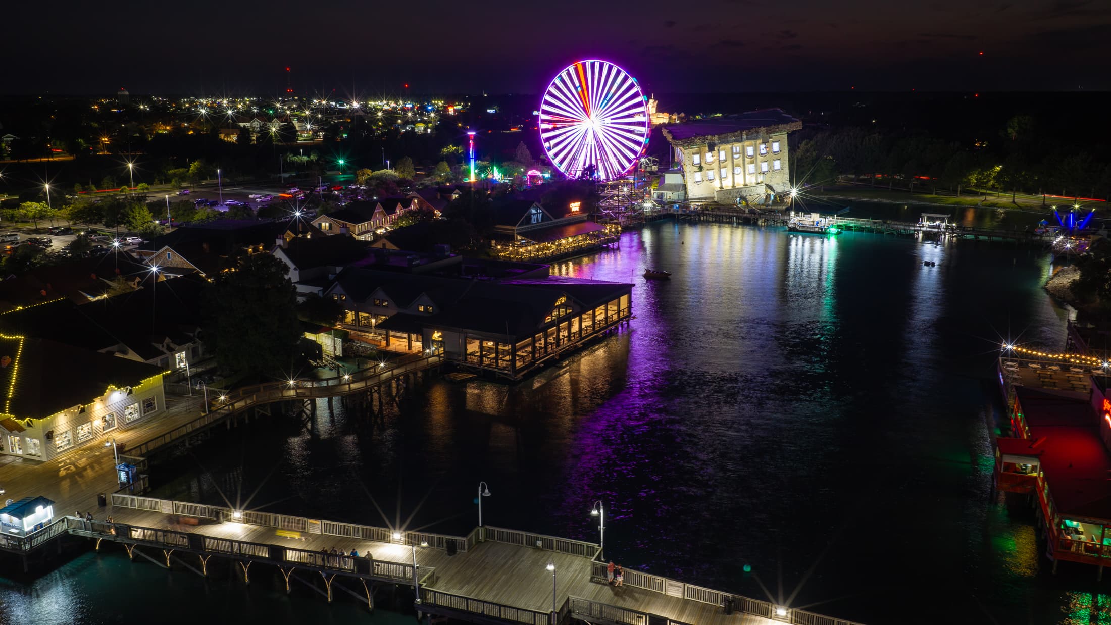 Big Fish and the illuminated waterfront at Broadway at the Beach after dark